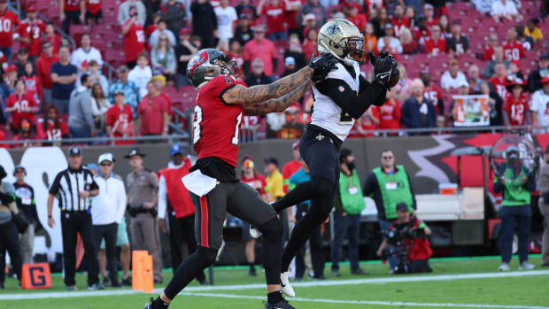Dec 31, 2023; Tampa, Florida, USA; New Orleans Saints cornerback Paulson Adebo (29) intercepted the ball for the 2-point conversion over Tampa Bay Buccaneers wide receiver Mike Evans (13) during the second half at Raymond James Stadium. Mandatory Credit: Kim Klement Neitzel-USA TODAY Sports